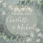 Sage Green String Lights Wedding Favour Thank You  Classic Round Sticker<br><div class="desc">Sage green wedding favour thank you classic round sticker featuring pretty string lights and signature style names. Personalise with your special thank you details in modern white typography. Designed by Thisisnotme©</div>