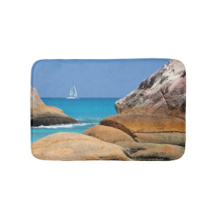 Sailboat Passing By the Beach Bath Mat