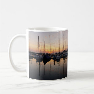 Sailboats in harbor with backlight. coffee mug