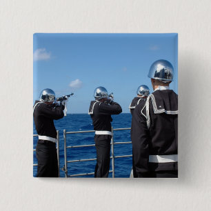 Sailors fire a gun salute during a burial-at-se 15 cm square badge