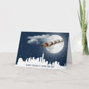 Santa and Sleigh Flying Over Big City Skyline Card