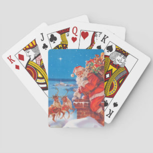 Santa Claus Up On The Rooftop With His Reindeer Playing Cards