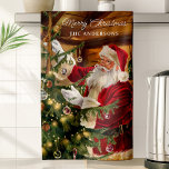 Santa Decorating Christmas Tree Personalised Tea Towel<br><div class="desc">Celebrate the magic of Christmas with this personalised kitchen towel featuring Santa Claus trimming the Christmas tree. With warm holiday colours and intricate details, this towel adds festive charm to your kitchen decor. Personalise it with your family name to make it a cherished holiday keepsake that brings warmth and nostalgia...</div>