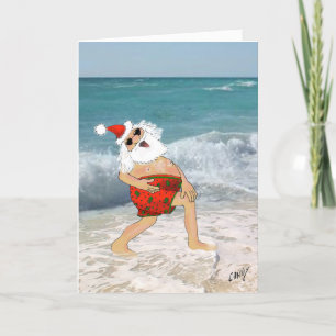 Santa frolicking on the beach in swimming trunks. holiday card