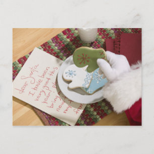 Santa hand with cookies and note holiday postcard