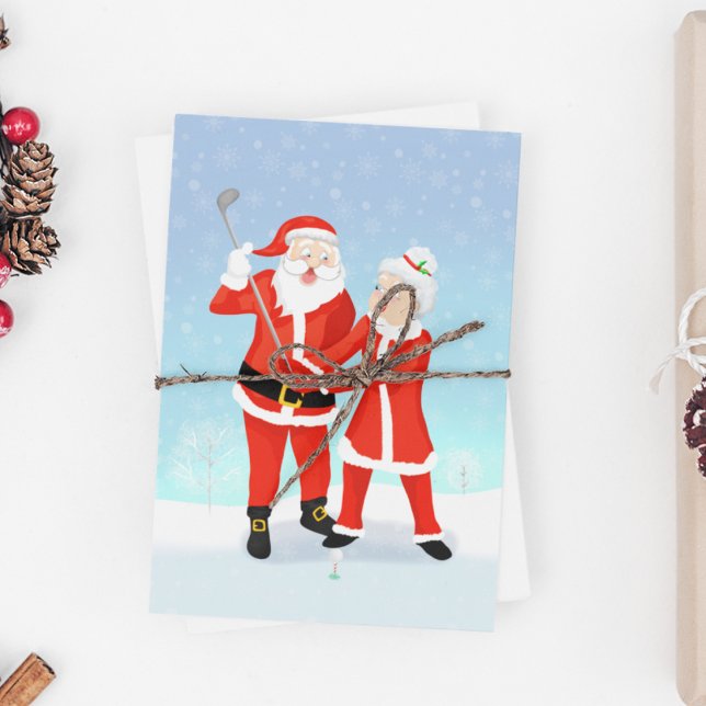 Santa Helping Mrs. Claus With Her Golf Swing Holiday Postcard (A wonderful Christmas card for the golf loving couple.)