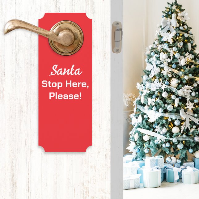 Santa Stop Here Please Festive Red Door Hanger (A red Christmas door handle hanger with message 'Santa Stop Here, Please!' in white typography)