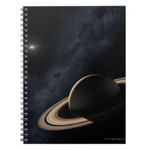 Saturn planet in solar system, close-up notebook