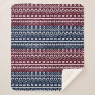 Scandinavian ornament on a blue, burgundy sherpa blanket