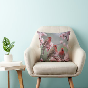 "Scarlet Trio: Red Finches Among Pink Blossoms" Cushion