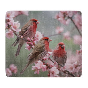 "Scarlet Trio: Red Finches Among Pink Blossoms" Cutting Board