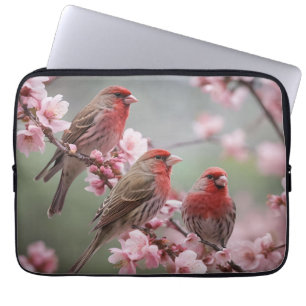 "Scarlet Trio: Red Finches Among Pink Blossoms" Laptop Sleeve
