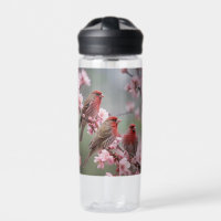 "Scarlet Trio: Red Finches Among Pink Blossoms"