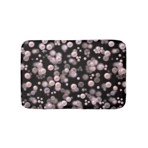 Scatterings of pink and white pearls on black velv bath mat