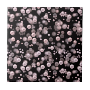 Scatterings of pink and white pearls on black velv ceramic tile