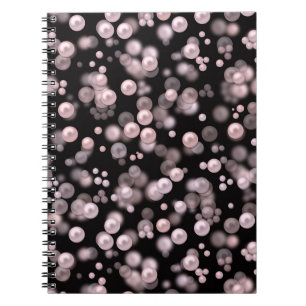 Scatterings of pink and white pearls on black velv notebook