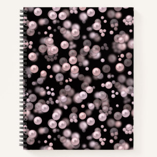 Scatterings of pink and white pearls on black velv notebook