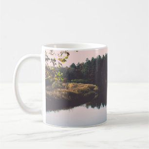 Scenic autumn coloured river in country with trees coffee mug