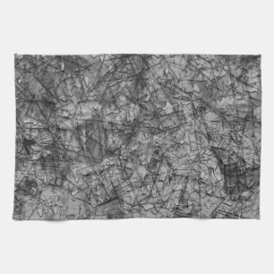 Scratches upon scratches on a lightly spotted grey tea towel