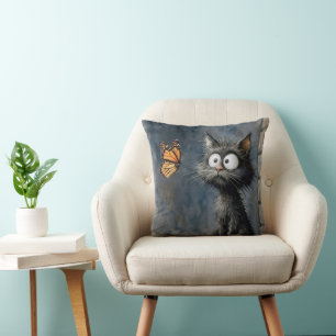 Scruffy Cat Staring at a Butterfly Cushion