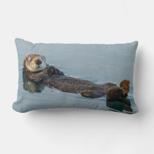 Sea otter floating on back in ocean lumbar cushion