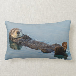 Sea otter floating on back in ocean lumbar cushion