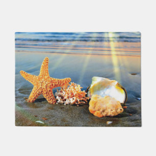 Sea shells and starfish on beach doormat