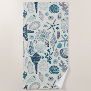 Sea shells on off white beach towel