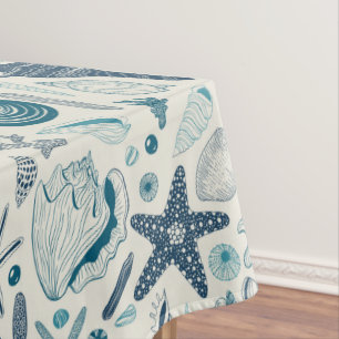 Sea shells on off white tablecloth