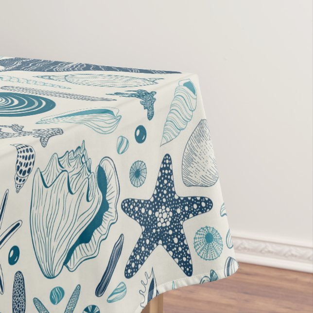 Sea shells on  off white tablecloth (In Situ)