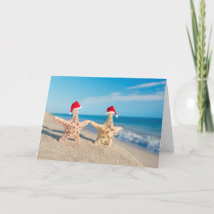 Sea-Stars Couple In Santa Hats Walking At Beach Holiday Card
