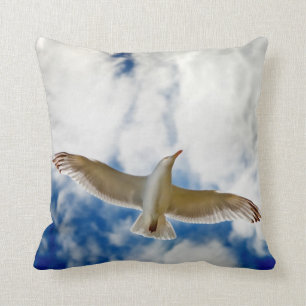 Seagul in flight with blue skies and white cloud, cushion