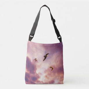 Seagulls flying in a sunset sky crossbody bag