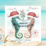 Seahorse Beach Mistletoe Kiss Married Christmas Holiday Card<br><div class="desc">Coastal theme newlywed Christmas card features watercolor seahorses in Santa hats kissing under mistletoe on the beach with a "Married Christmas" caption. The holiday greeting and names can be personalised. Visit my "Seahorse Coastal Christmas Kiss" collection for coordinating invitations,  party supplies,  decor and more. Art by KL Stock.</div>