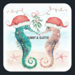 Seahorse Kiss Beach Christmas Couples Shower Square Sticker<br><div class="desc">Add a cute coastal touch when you send out your invitations with these beach theme Christmas couples shower stickers! Featuring a watercolor seahorse couple on a tropical beach wearing Santa hats and kissing under mistletoe. Perfect for winter and Christmas time shower celebrations. Art by KL Stock.</div>