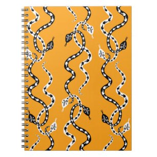 Seamless background of creeping decorative snakes notebook
