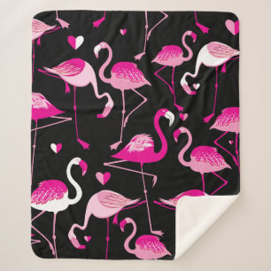 Seamless pattern from pink flamingos on a dark bac sherpa blanket