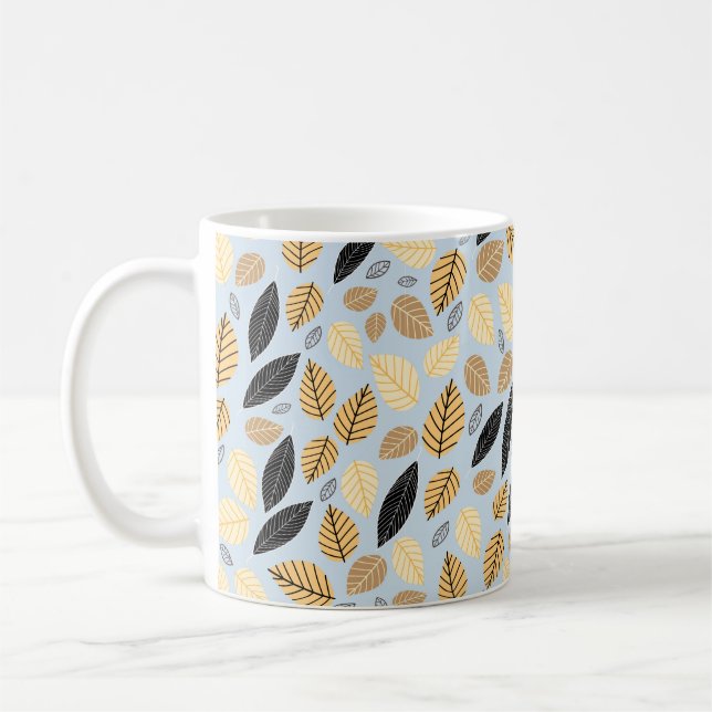 Seamless pattern of autumn leaves on a blue backgr coffee mug (Left)