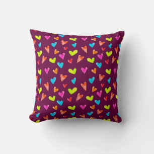 Seamless pattern of multicolored hearts on a purpl cushion