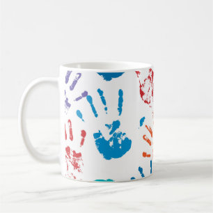 Seamless pattern of multicolored human hands on a coffee mug