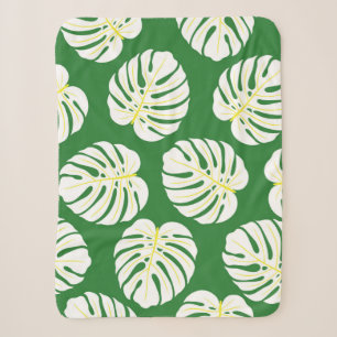 Seamless pattern of white monstera leaves on a dar sherpa blanket