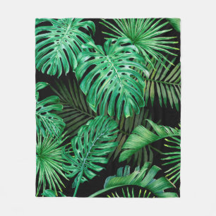 Seamless pattern with tropical leaves on a dark ba fleece blanket