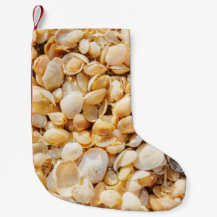 Seashell textured summer beach background. small christmas stocking