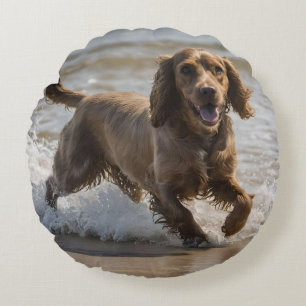 "Seaside Fun: A Cocker Spaniel Play in the Ocean Round Cushion