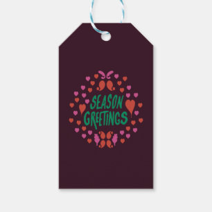 Season greetings in green handwriting with hearts gift tags