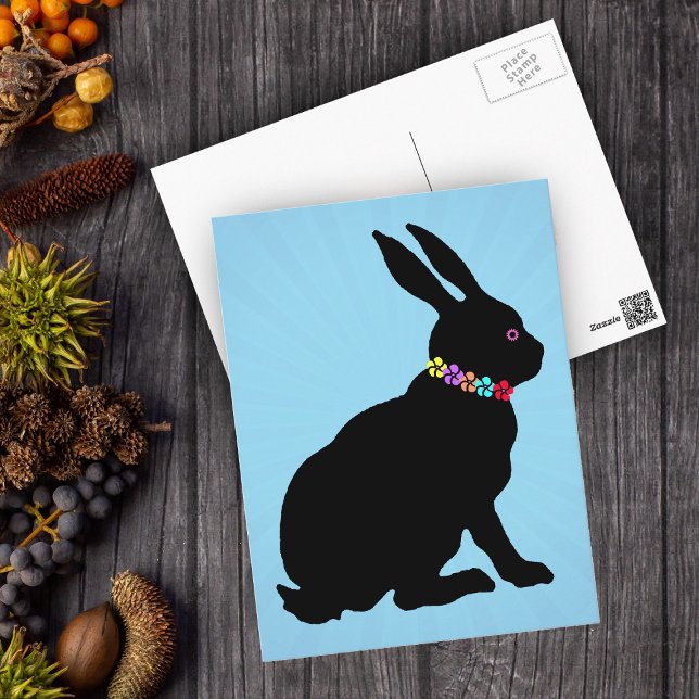 Seated Black Rabbit in Silhouette Pretty Flowers Postcard (Black silhouette sitting Easter or Spring Time rabbit wearing flowers on blue postcard.)