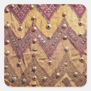 Section of embroidered fabric with gold plaques square sticker