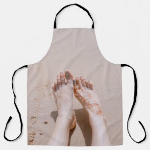Selective focus photography of feet with tattoo on apron