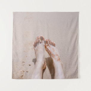 Selective focus photography of feet with tattoo on tapestry