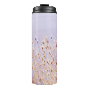 SELECTIVE FOCUS PHOTOGRAPHY OF GRASS FIELD THERMAL TUMBLER
